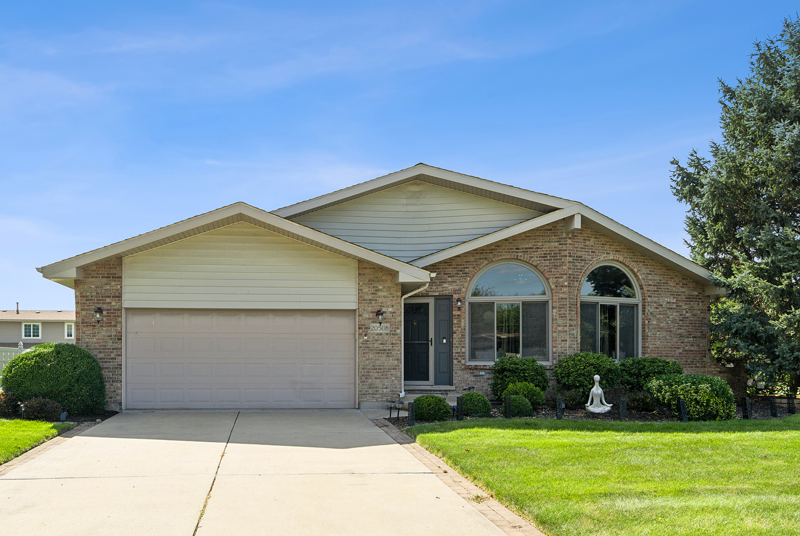 a front view of a house with garden