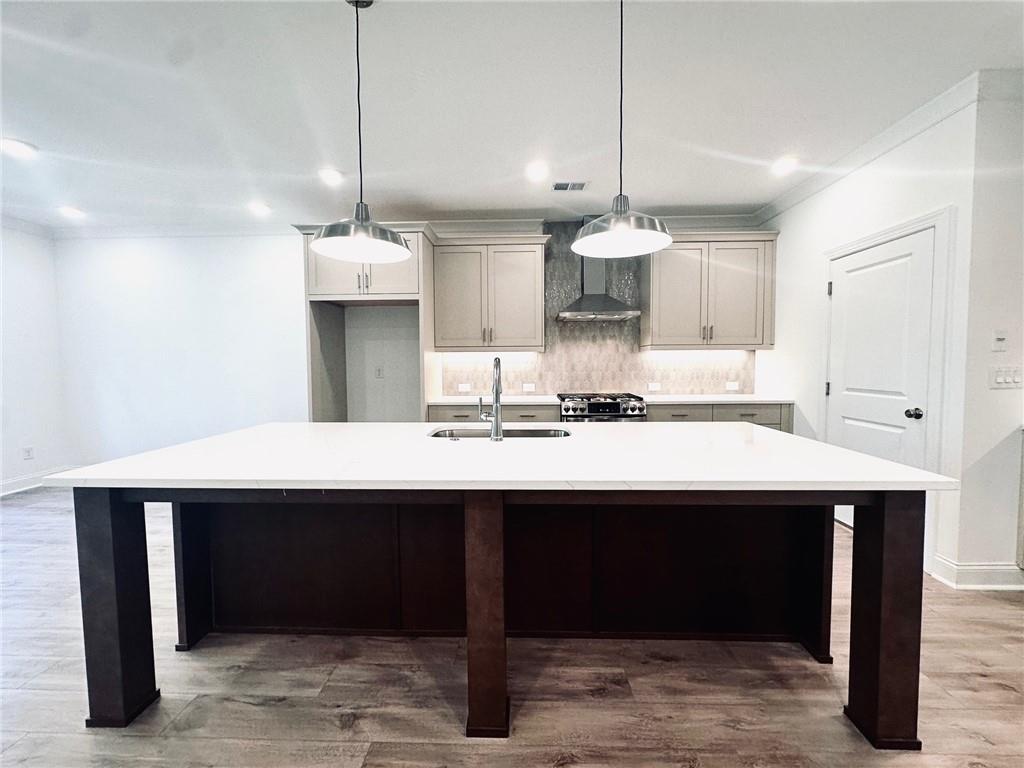 a kitchen with a sink a counter space and cabinets