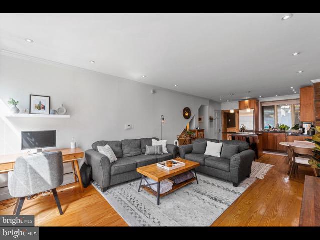 a living room with furniture a rug and a table