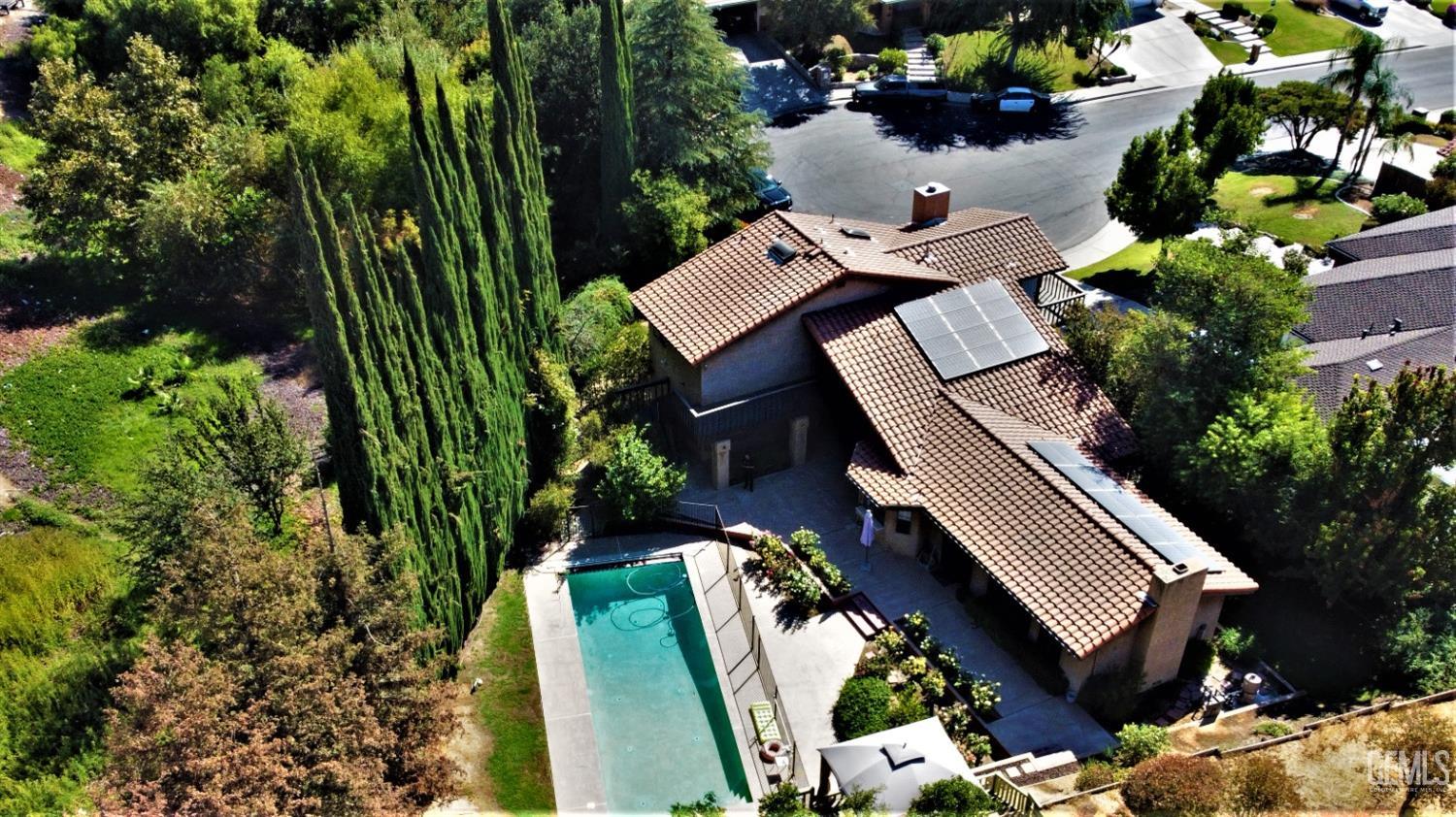 an aerial view of a house with a yard and a garden