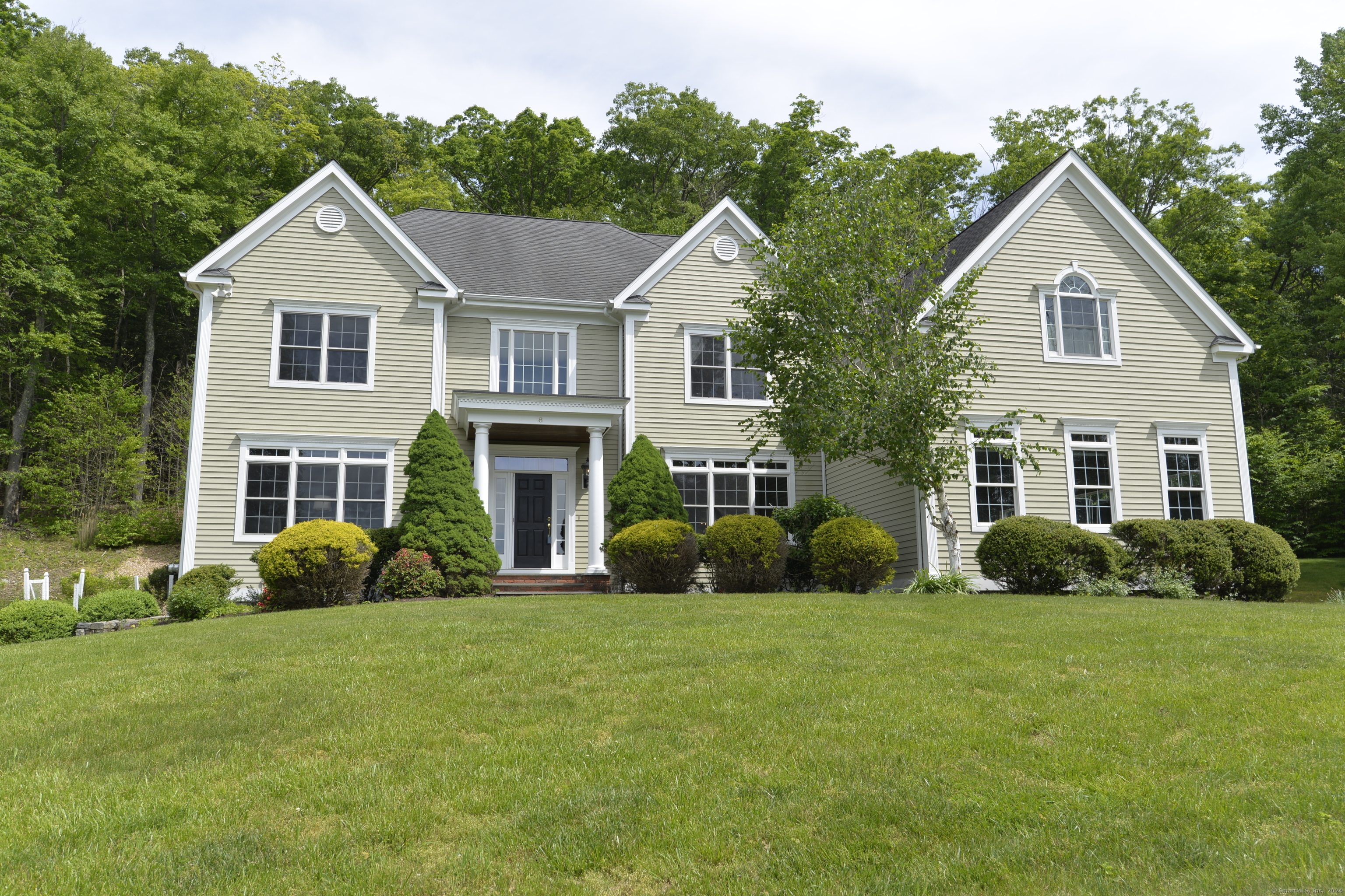 a front view of a house with garden