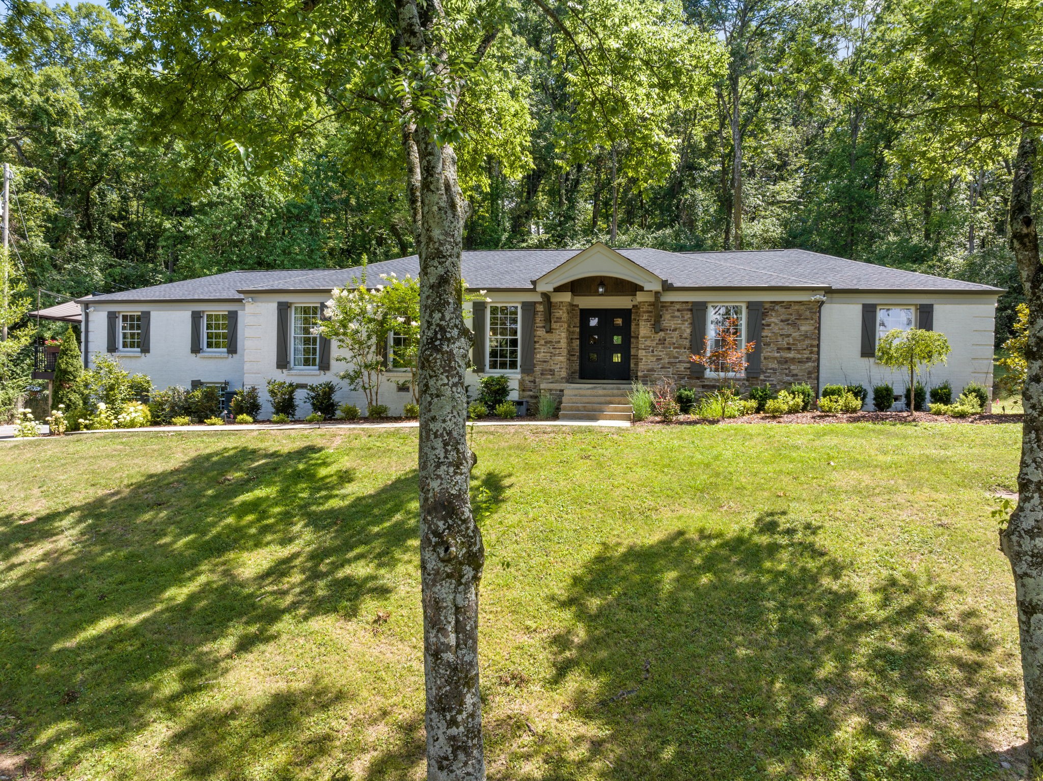 a front view of house with yard and green space