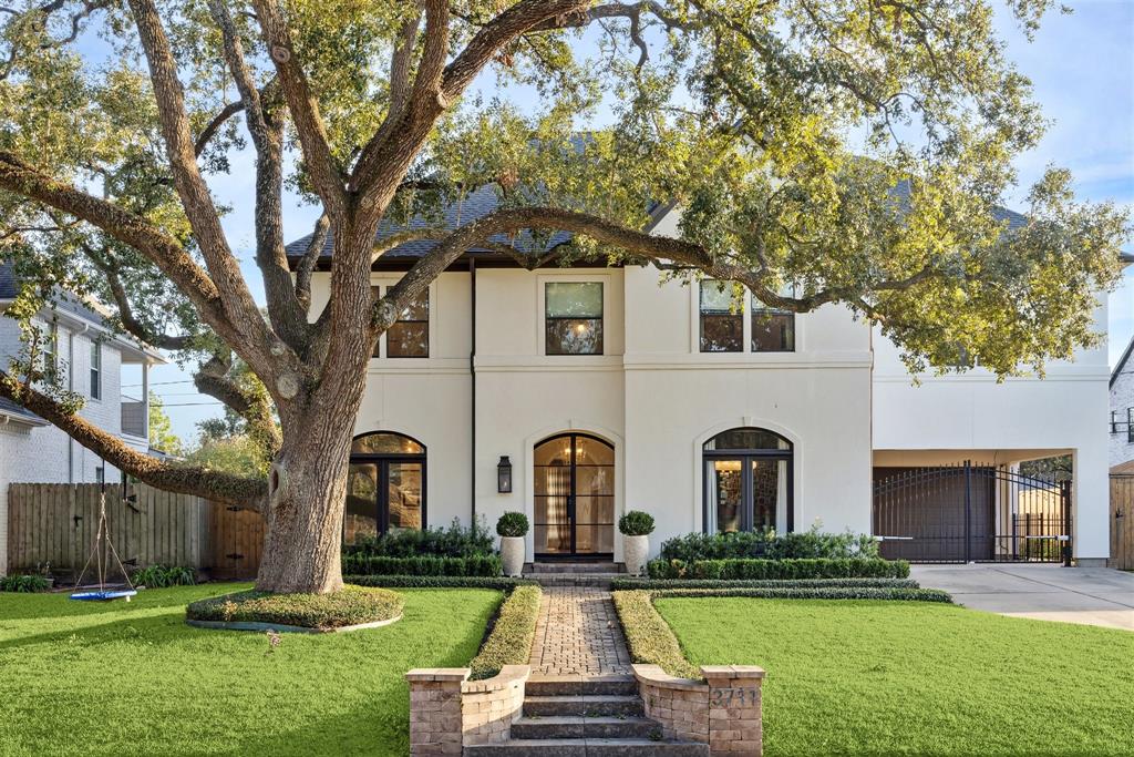 A hidden gem inside the loop on an enviable street in Braes Heights. Featuring a stucco exterior with arch-top windows, recent roof, and a well-manicured lawn. A mature oak tree adds charm to the front yard, which includes a brick pathway leading to the entrance.