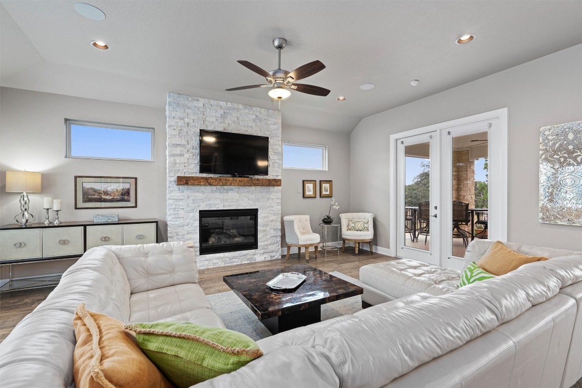 a living room with furniture a flat screen tv and a fireplace