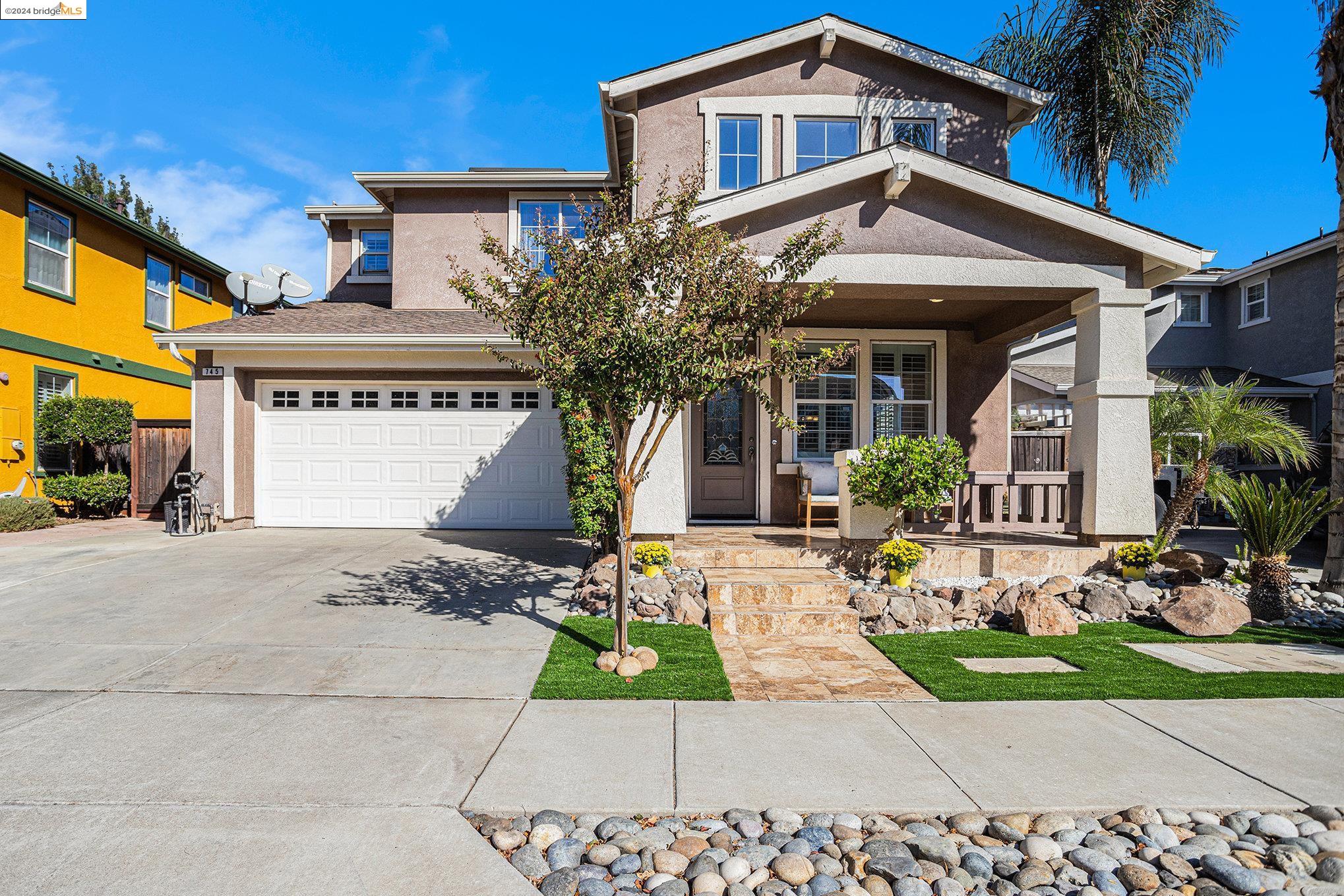 a front view of a house with garden