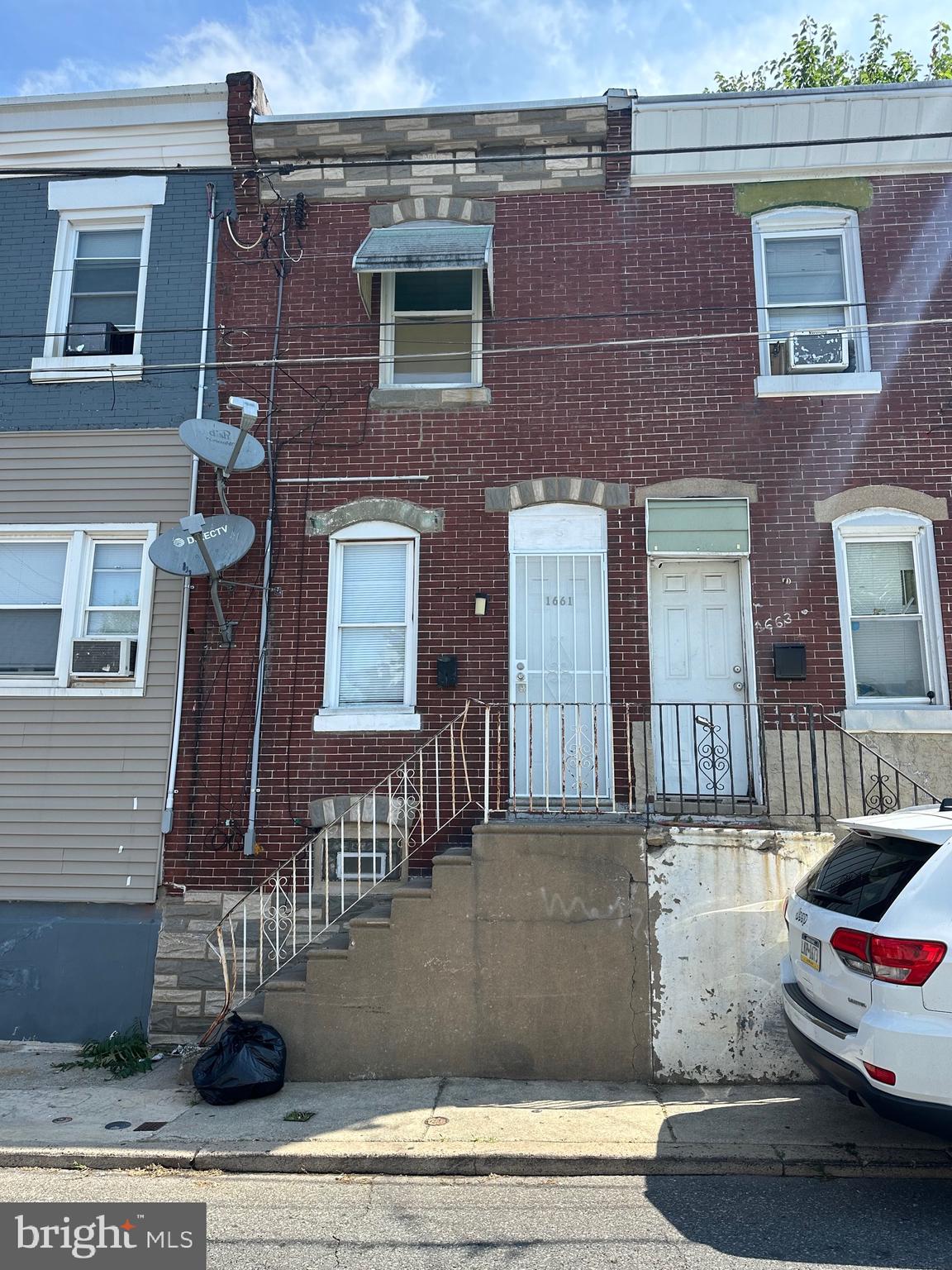 a view of a brick house with many windows