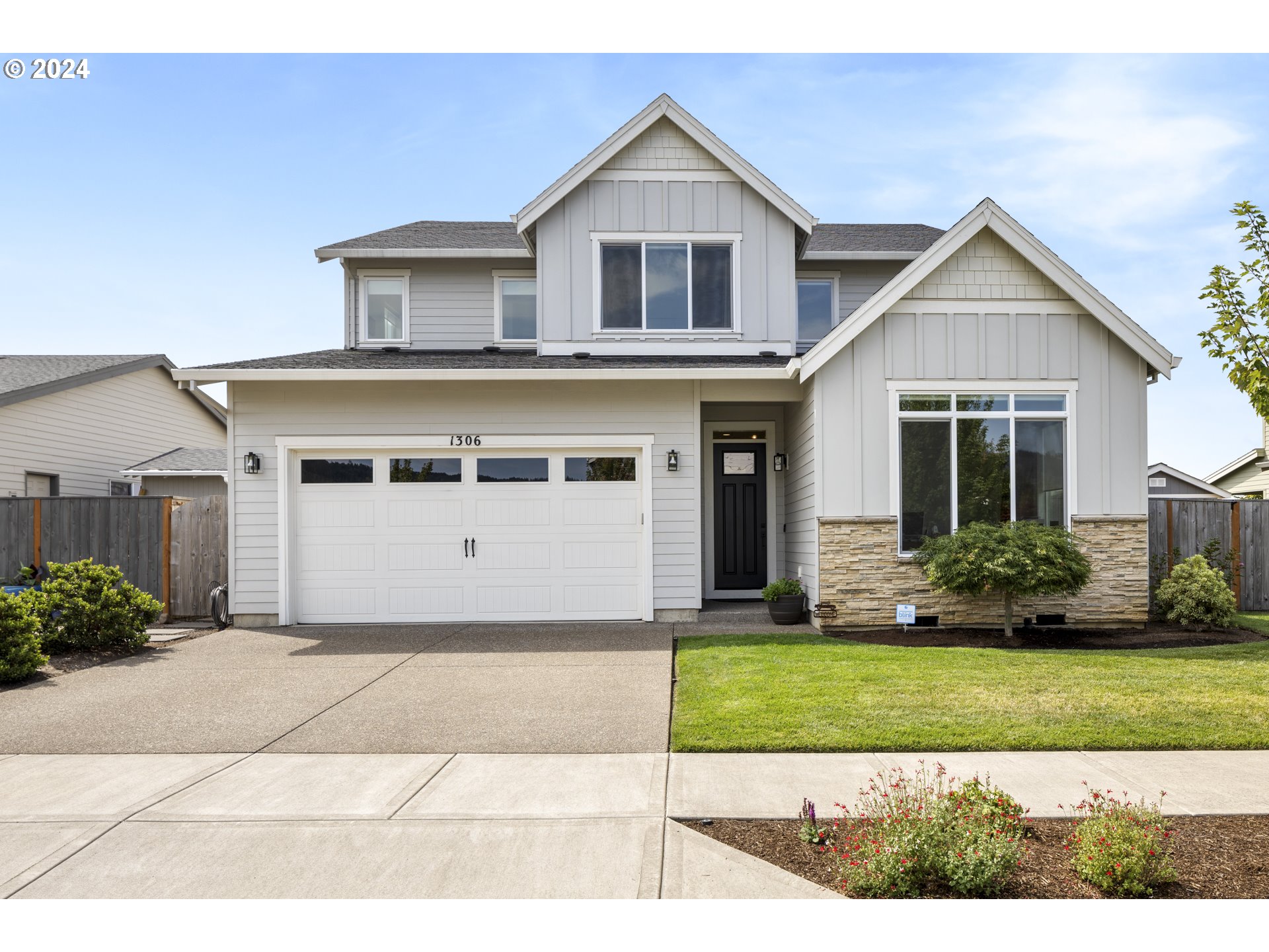 a front view of a house with a yard and garage