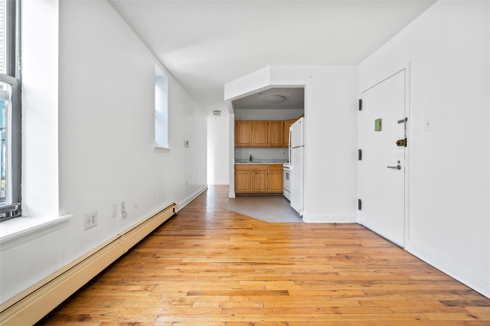 a view of a room with wooden floor and sink