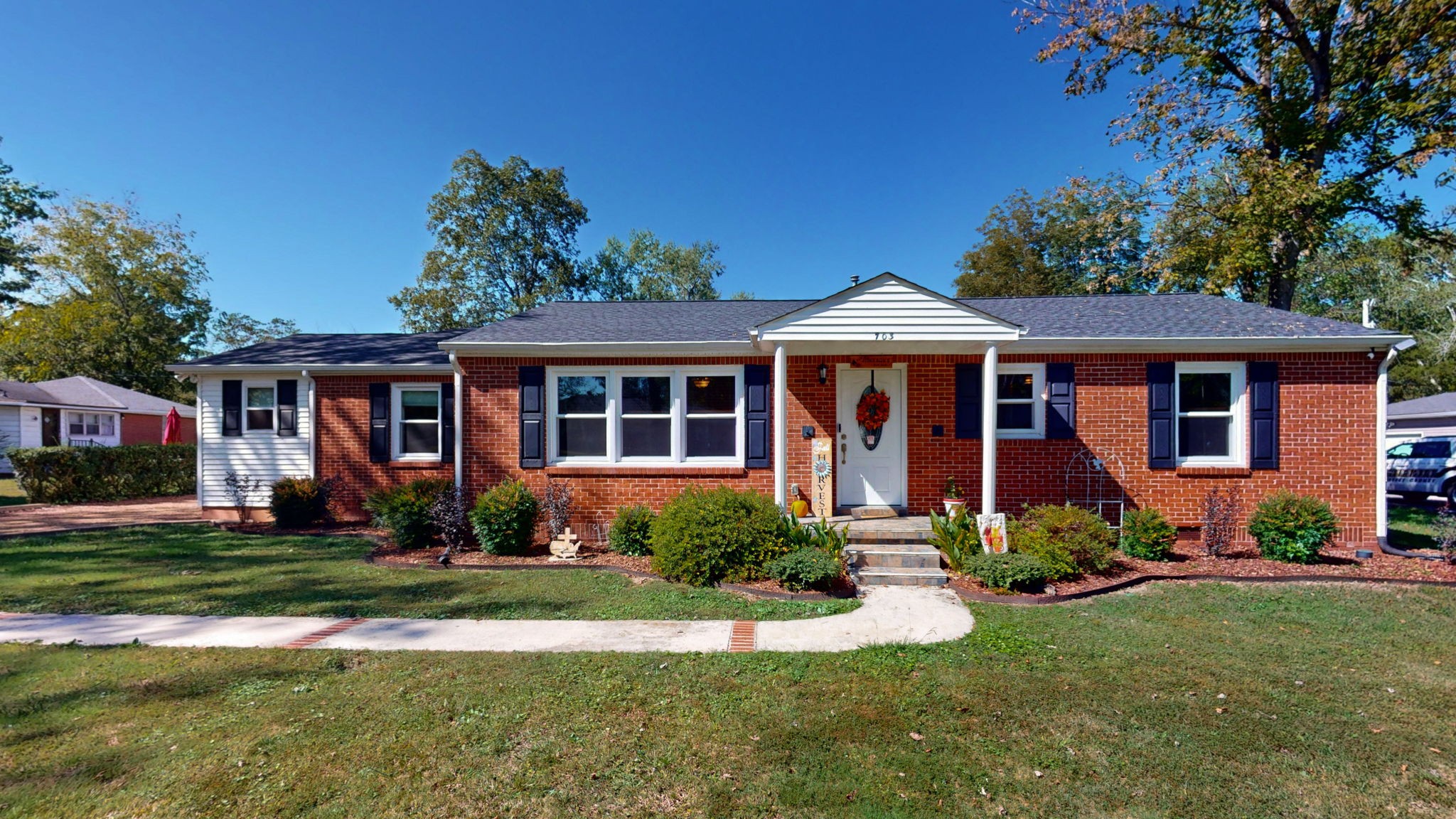 a front view of a house with a yard and porch