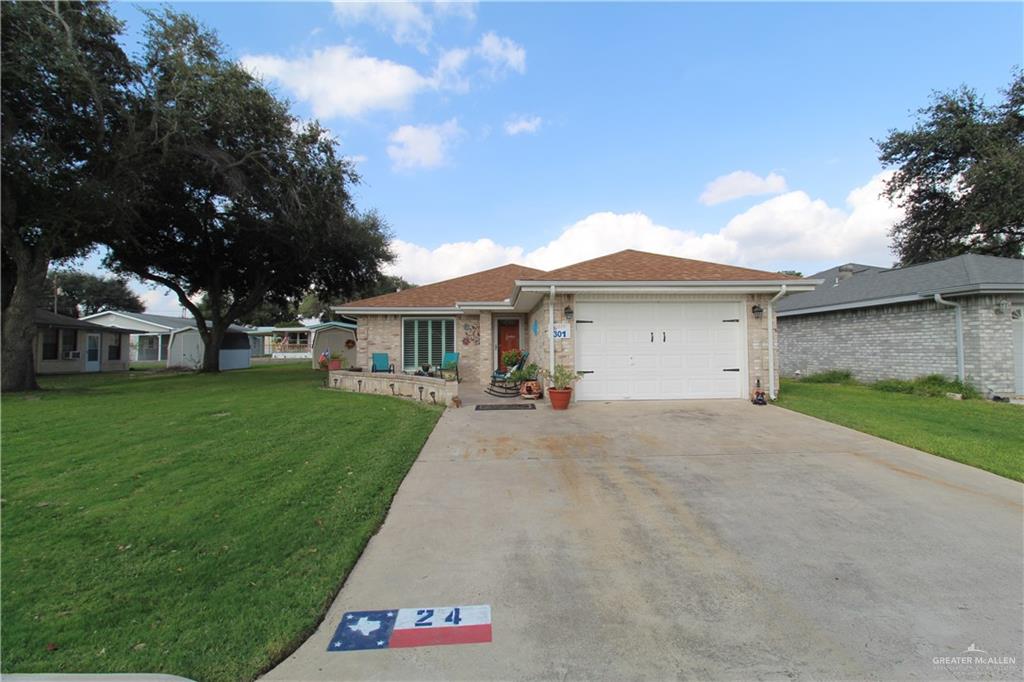 a front view of a house with a yard and garage