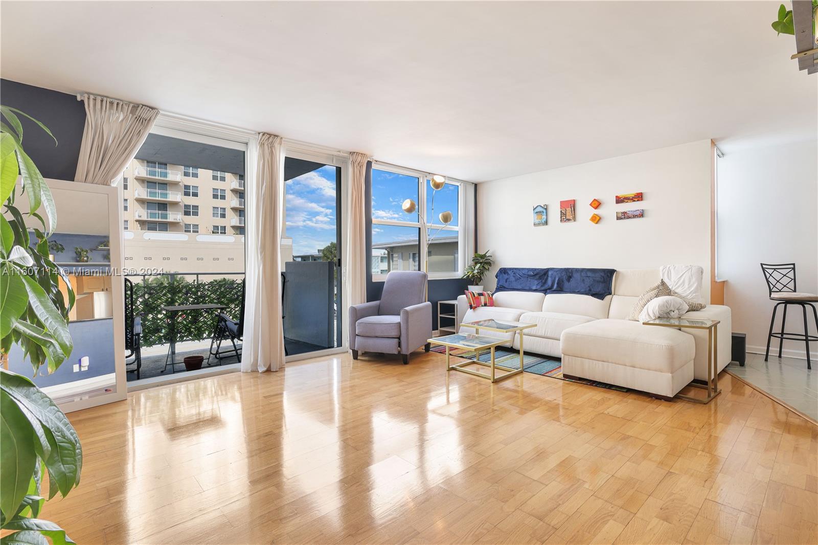 a living room with furniture and large windows