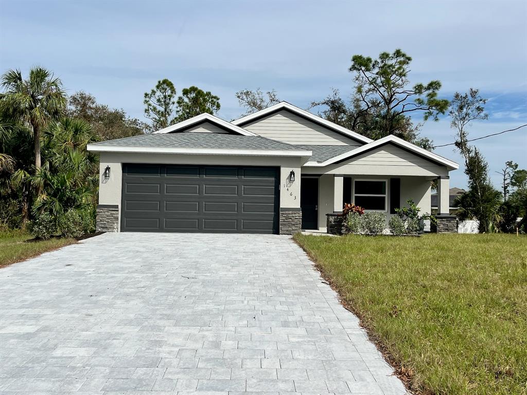 a front view of a house with a yard and garage