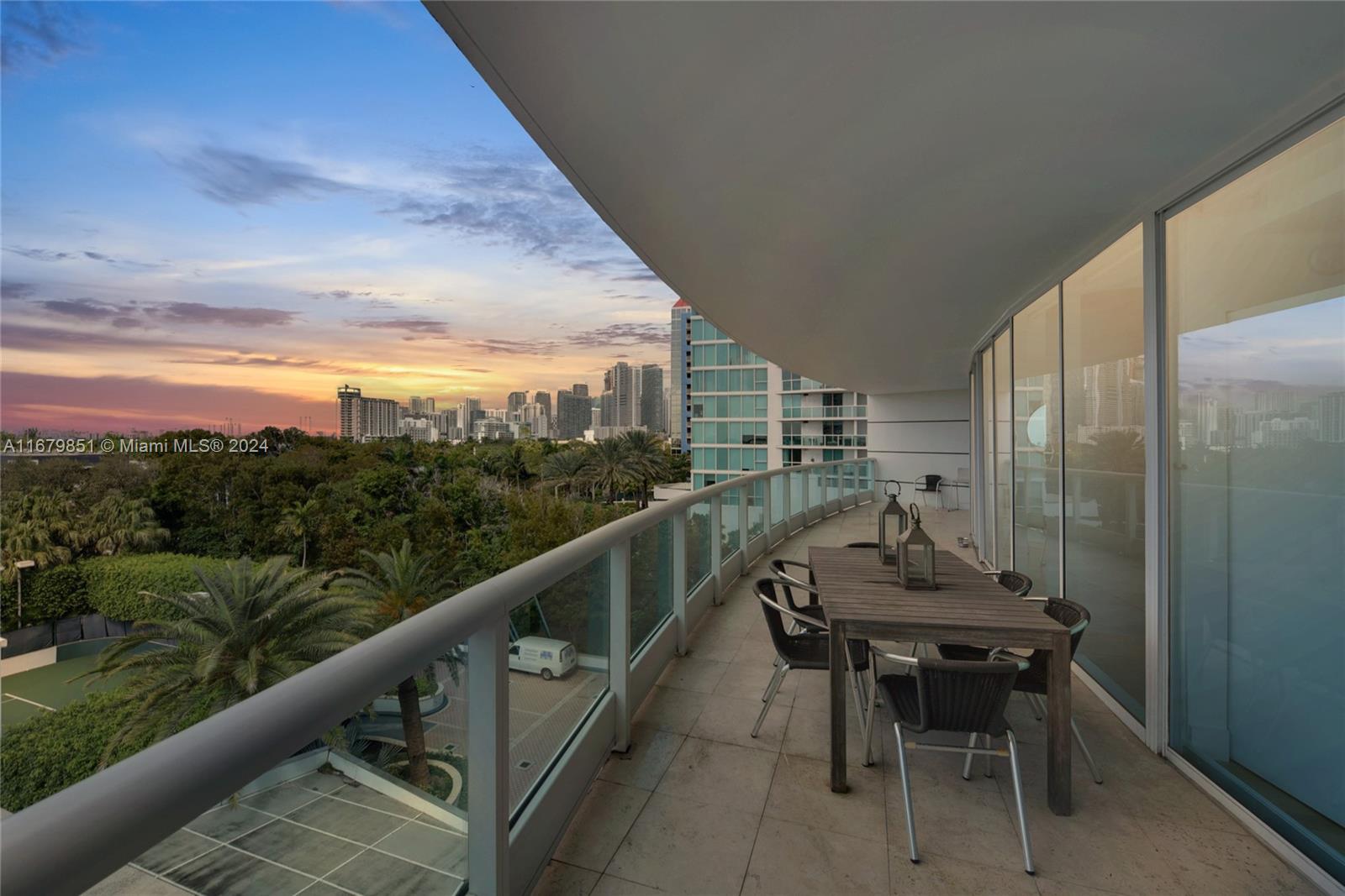 a balcony with table and chairs