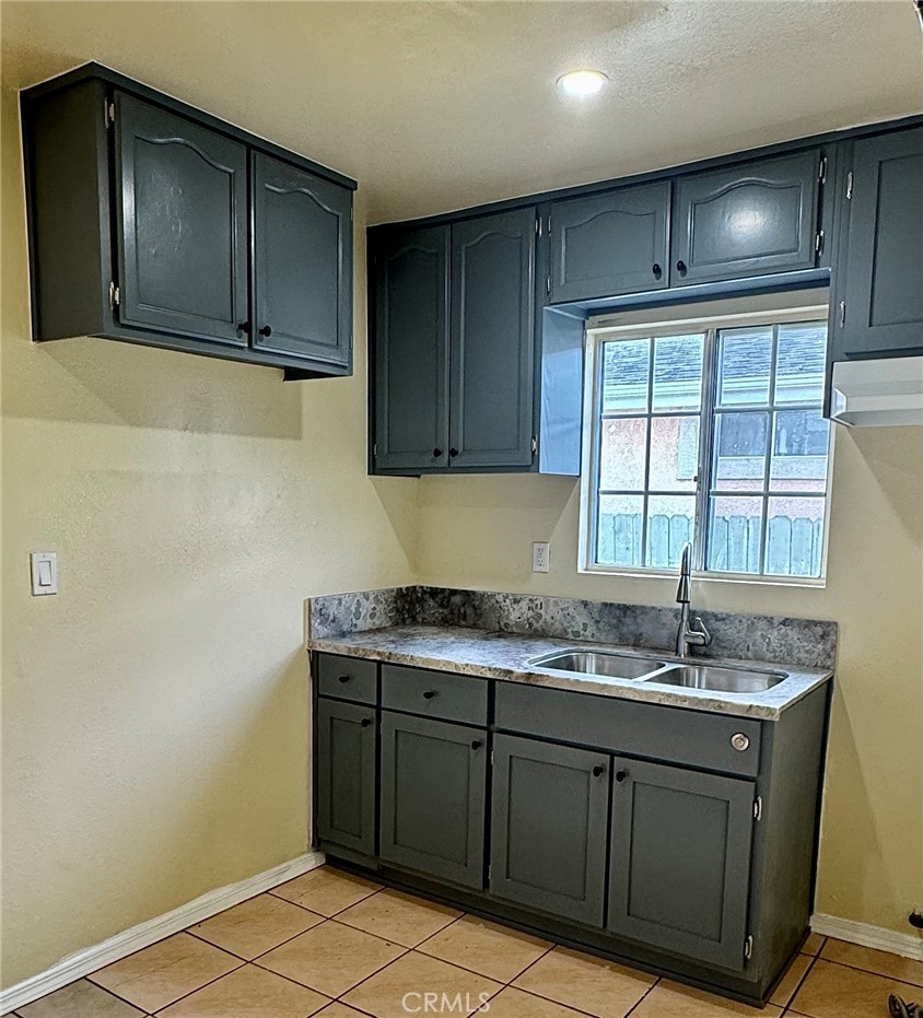 a kitchen with a sink and cabinets