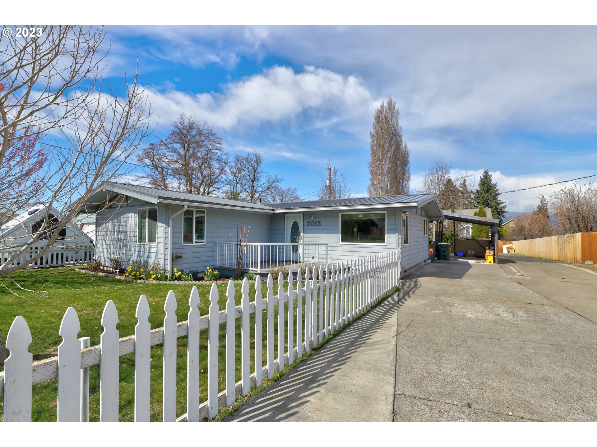 a view of a house with wooden fence