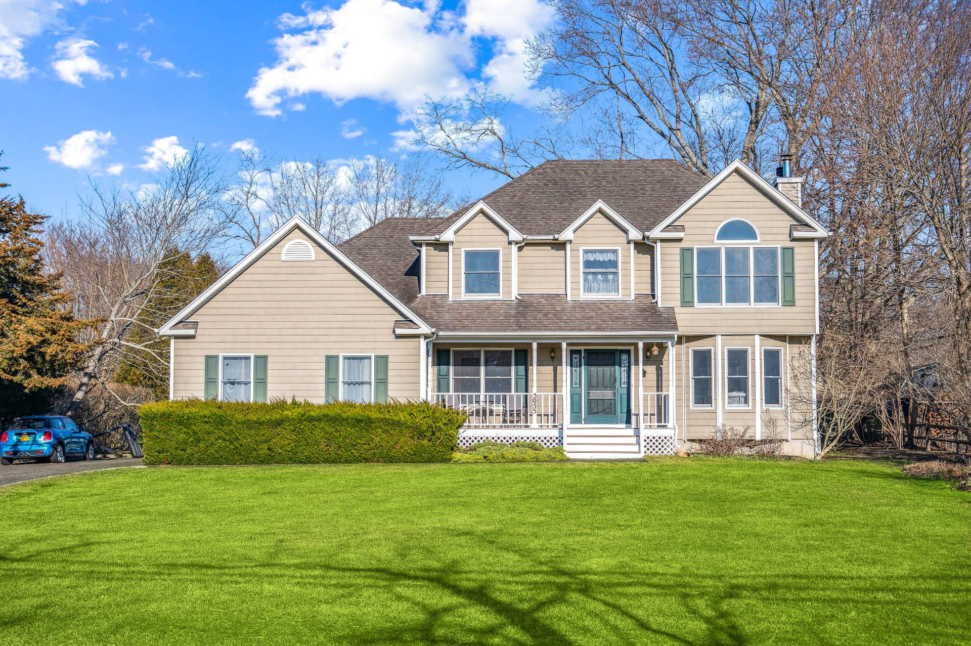 a front view of a house with a garden