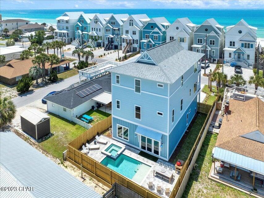 an aerial view of residential houses with outdoor space