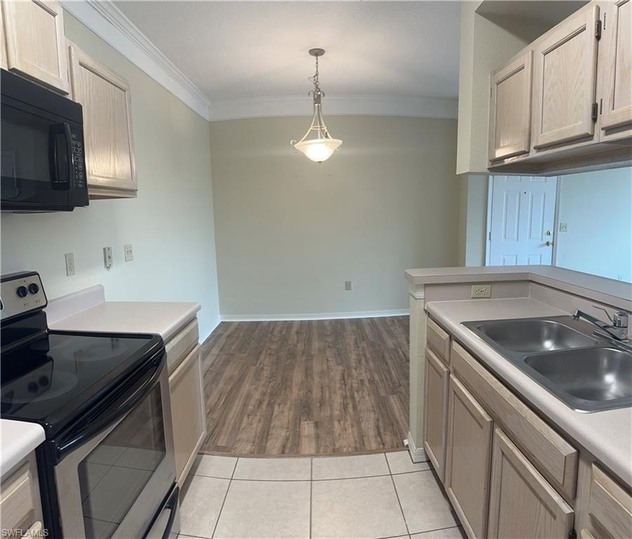 a kitchen that has a sink and a stove