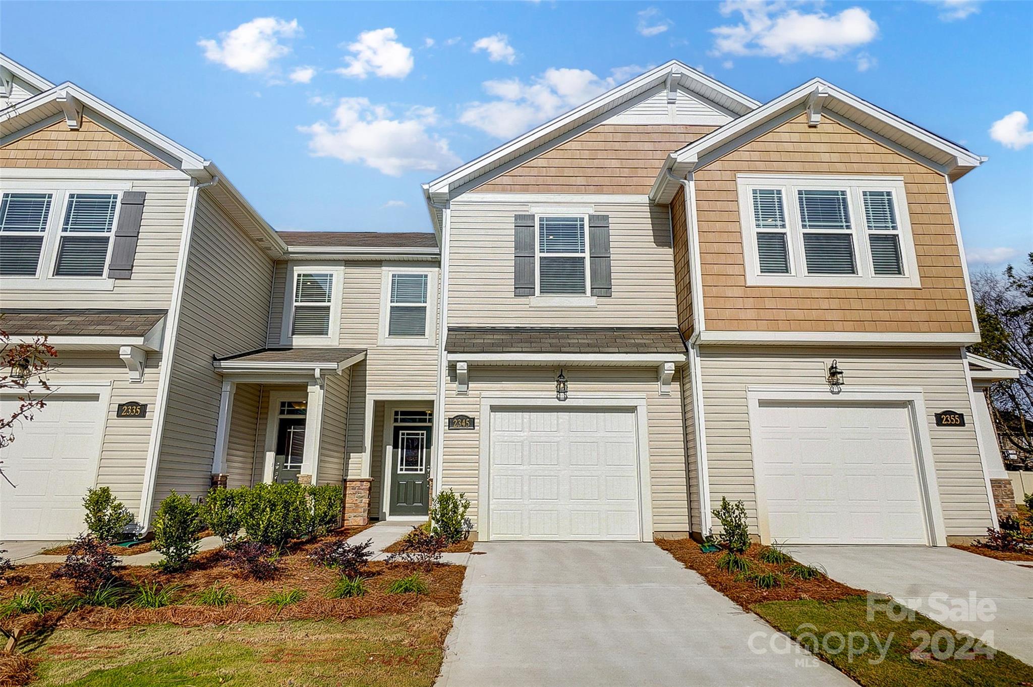 a front view of a house with yard and seating space