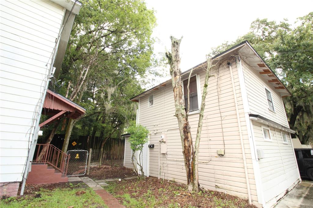 a view of house with backyard and seating area