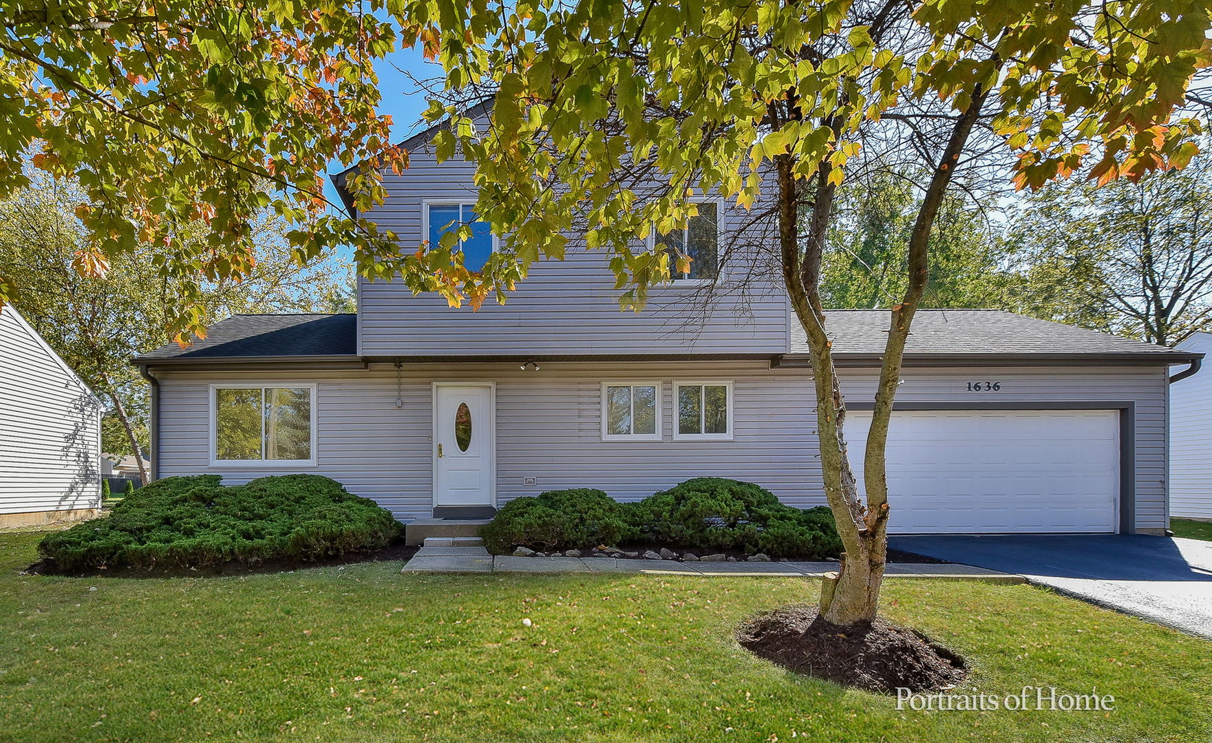 a front view of a house with a yard