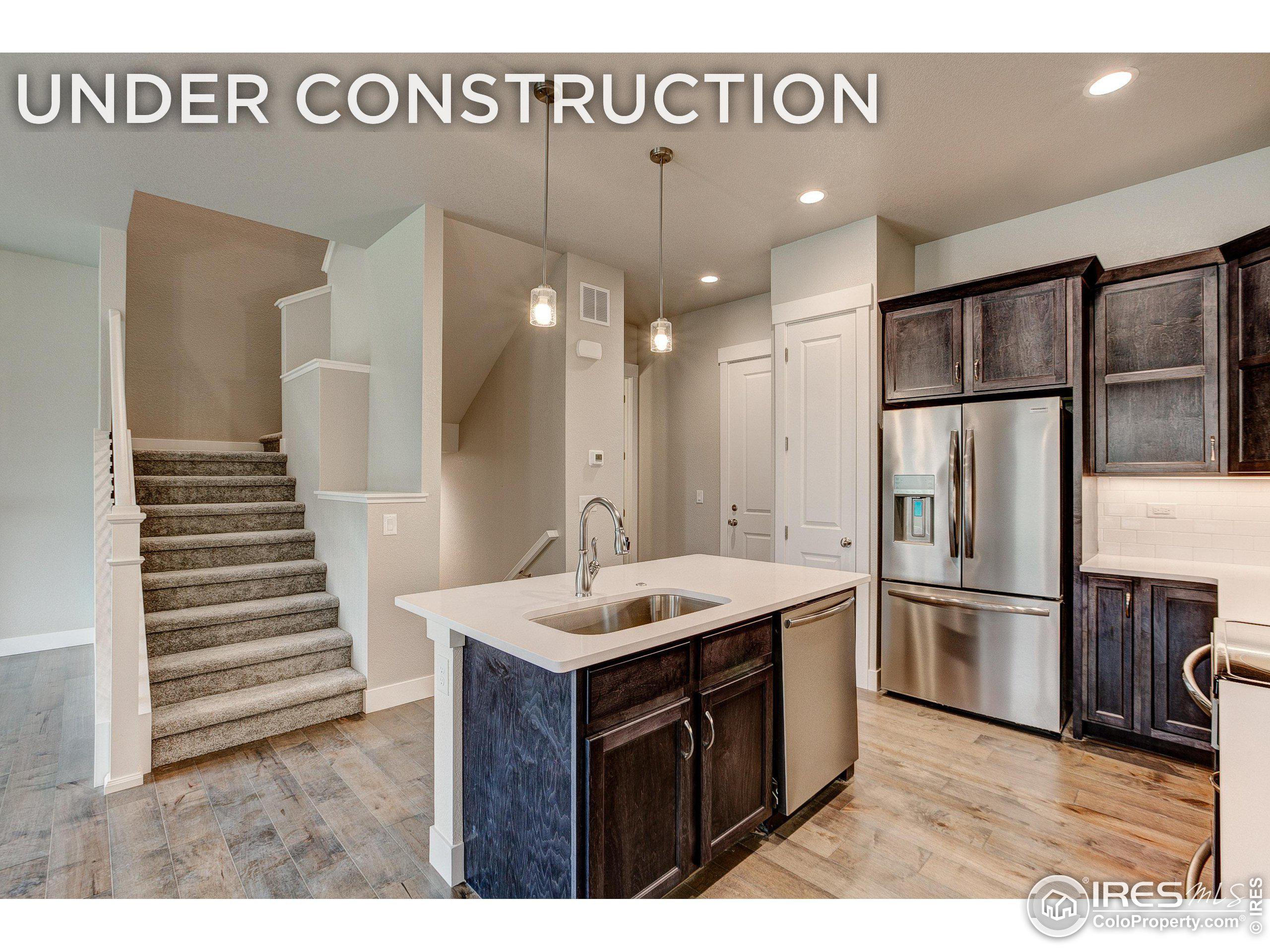 a kitchen with a sink refrigerator and cabinets