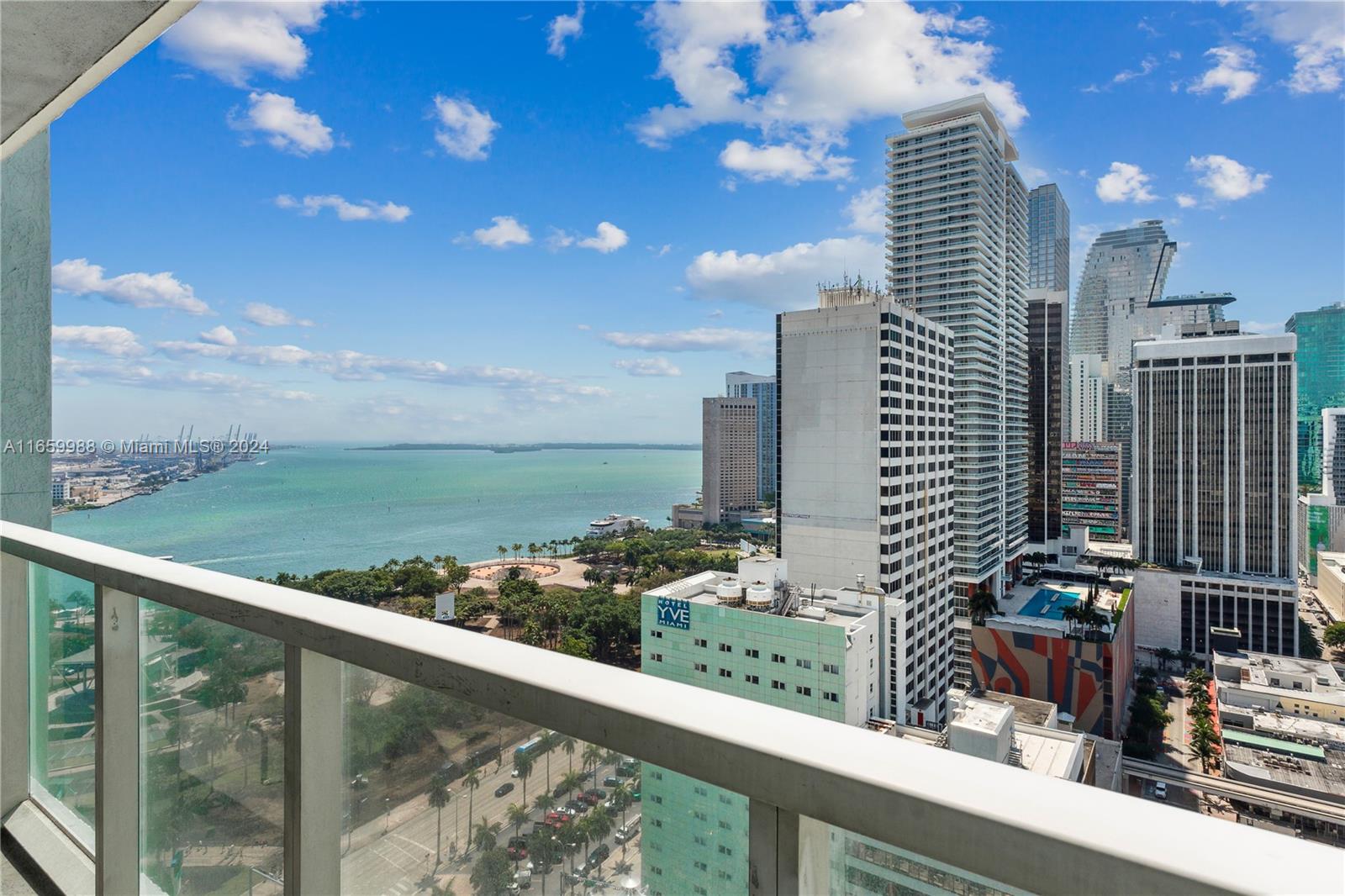 a city view from a balcony with outdoor seating