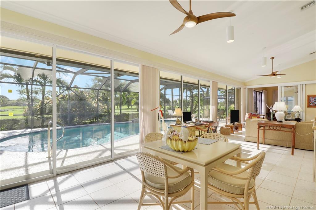 a dining room with furniture a chandelier and fireplace