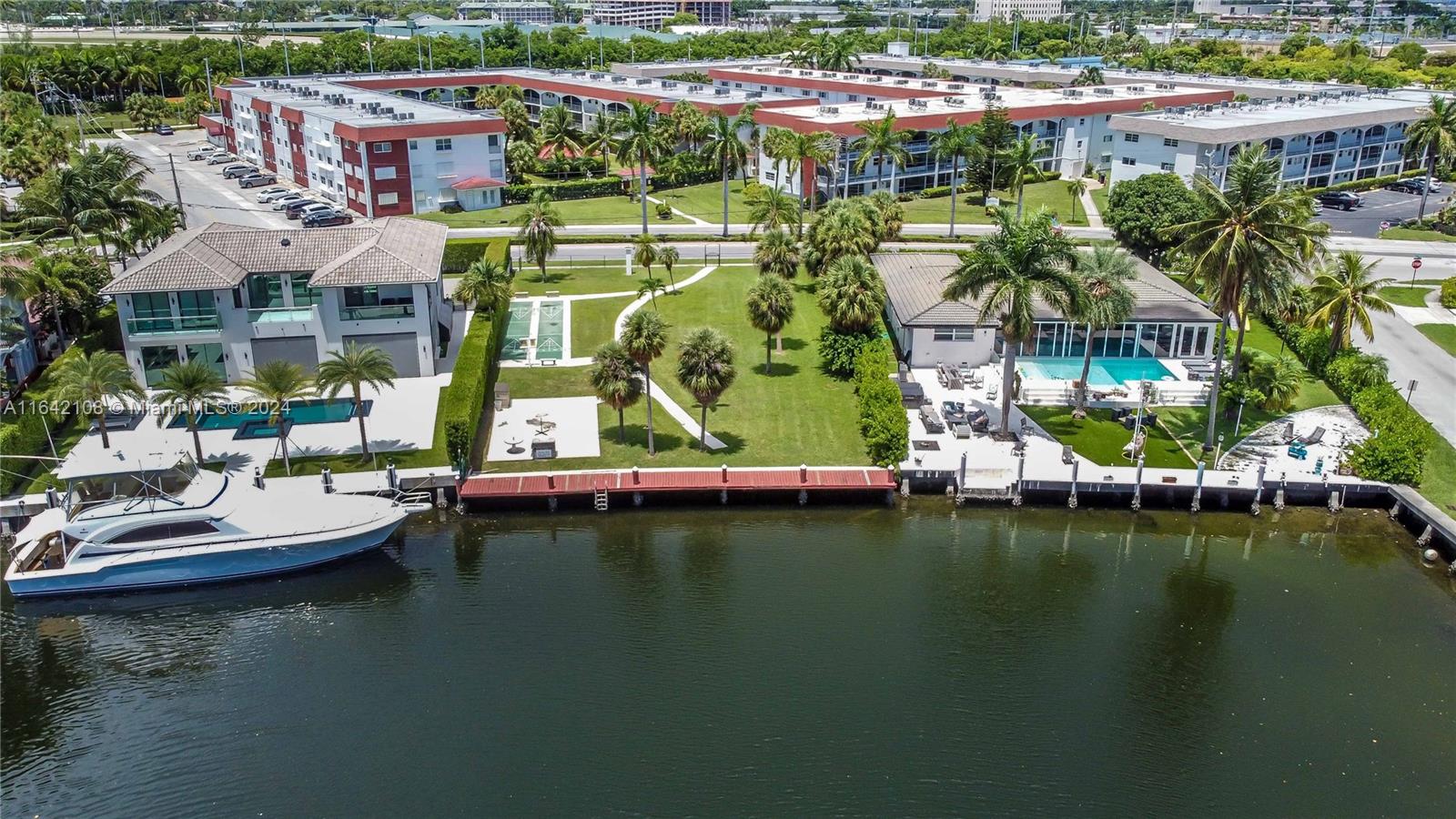 an aerial view of a house with a garden and lake view