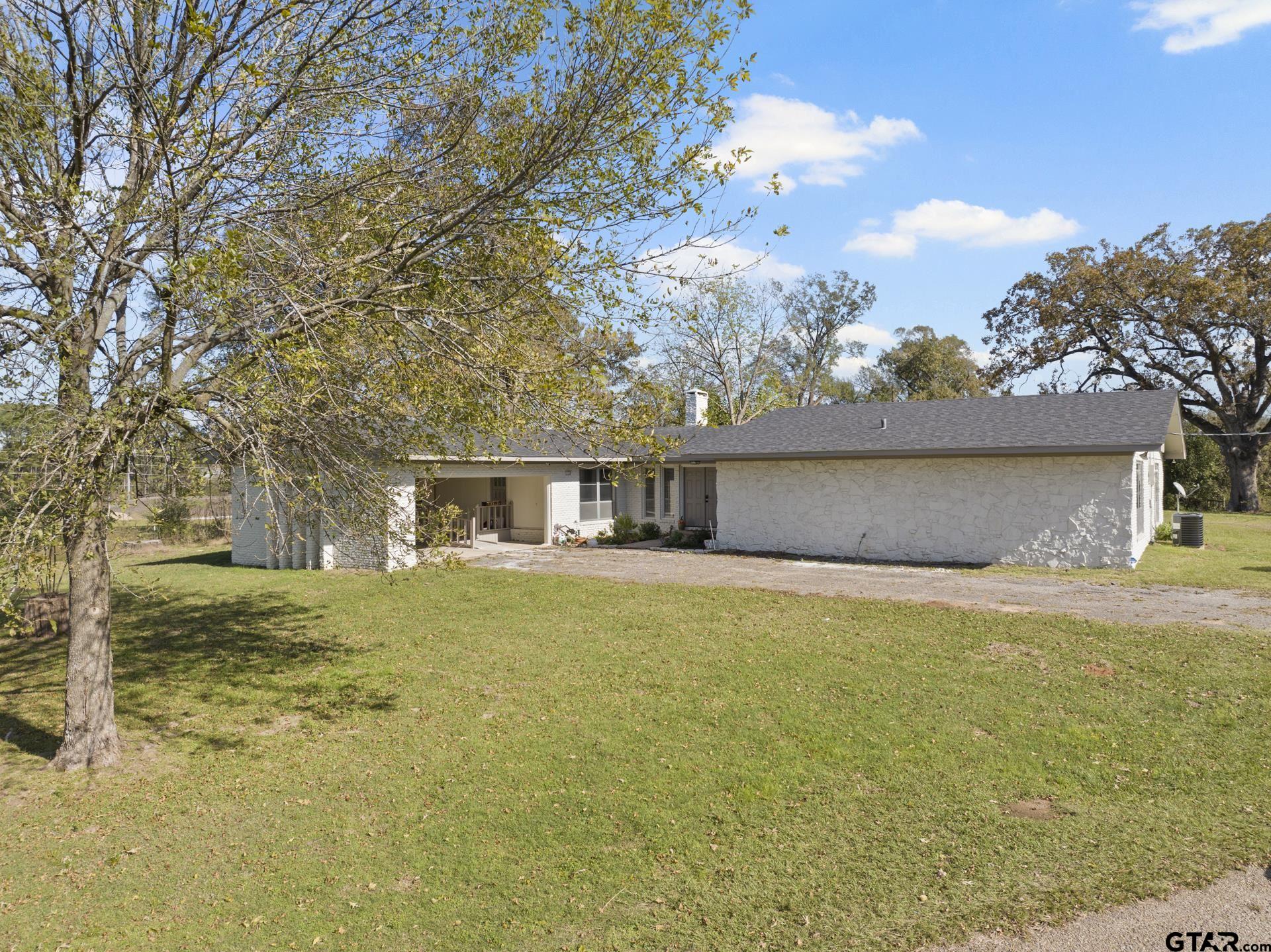 a front view of house with yard and trees