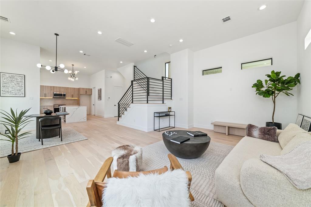 a living room with furniture a chandelier and a flat screen tv