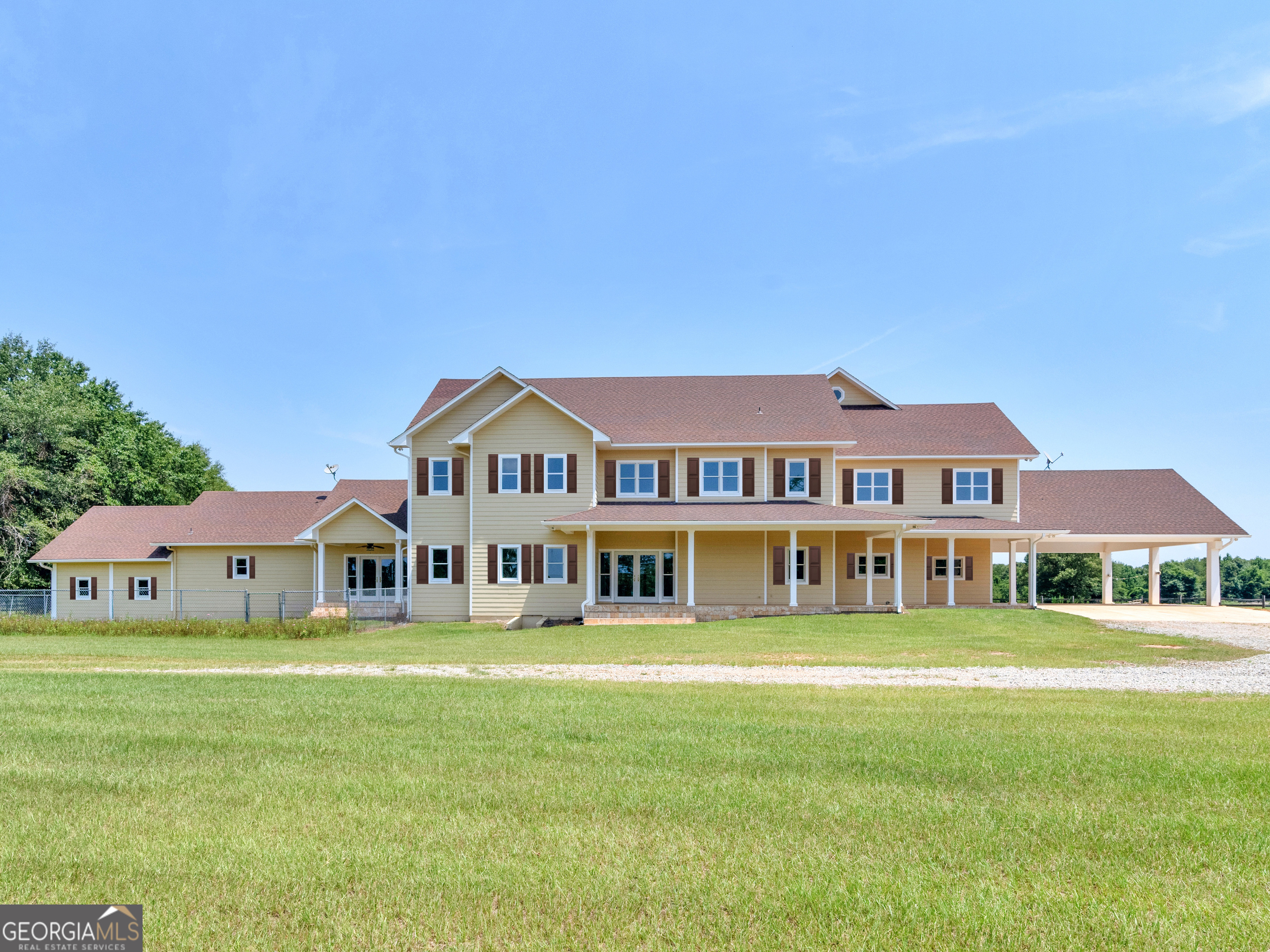 a front view of a building with garden and deck