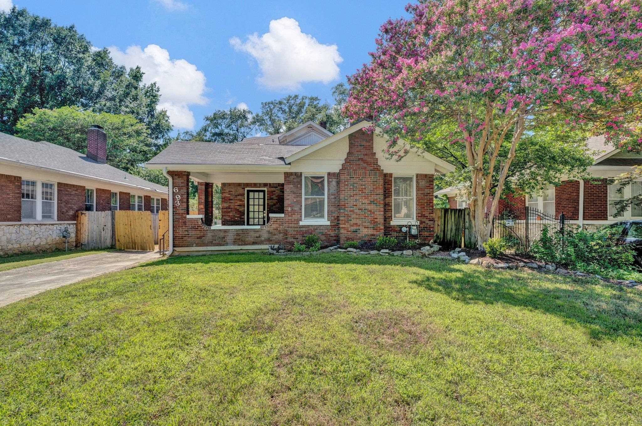 Single story home featuring a porch and a front yard