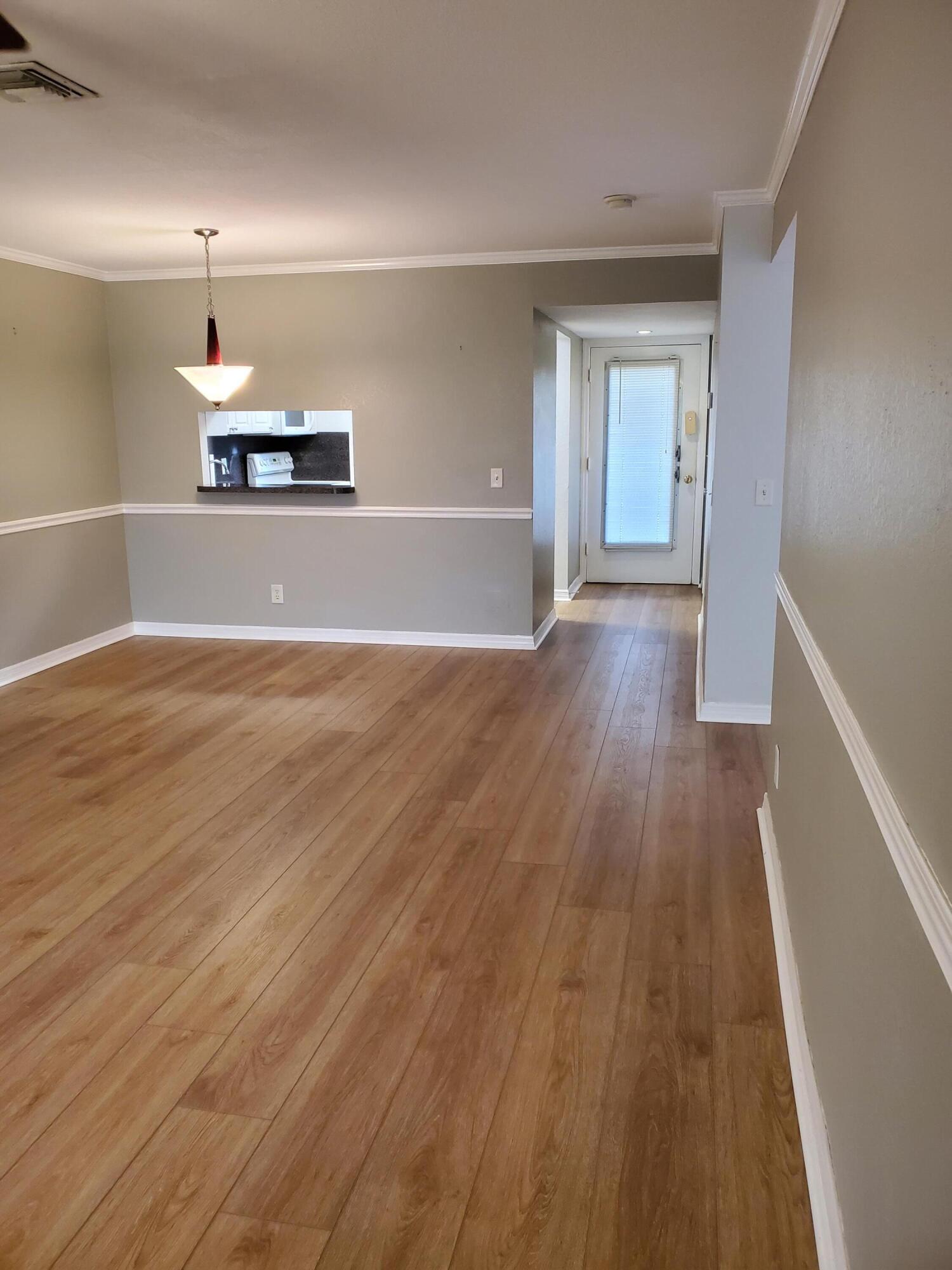 a view of a kitchen with wooden floor and a sink