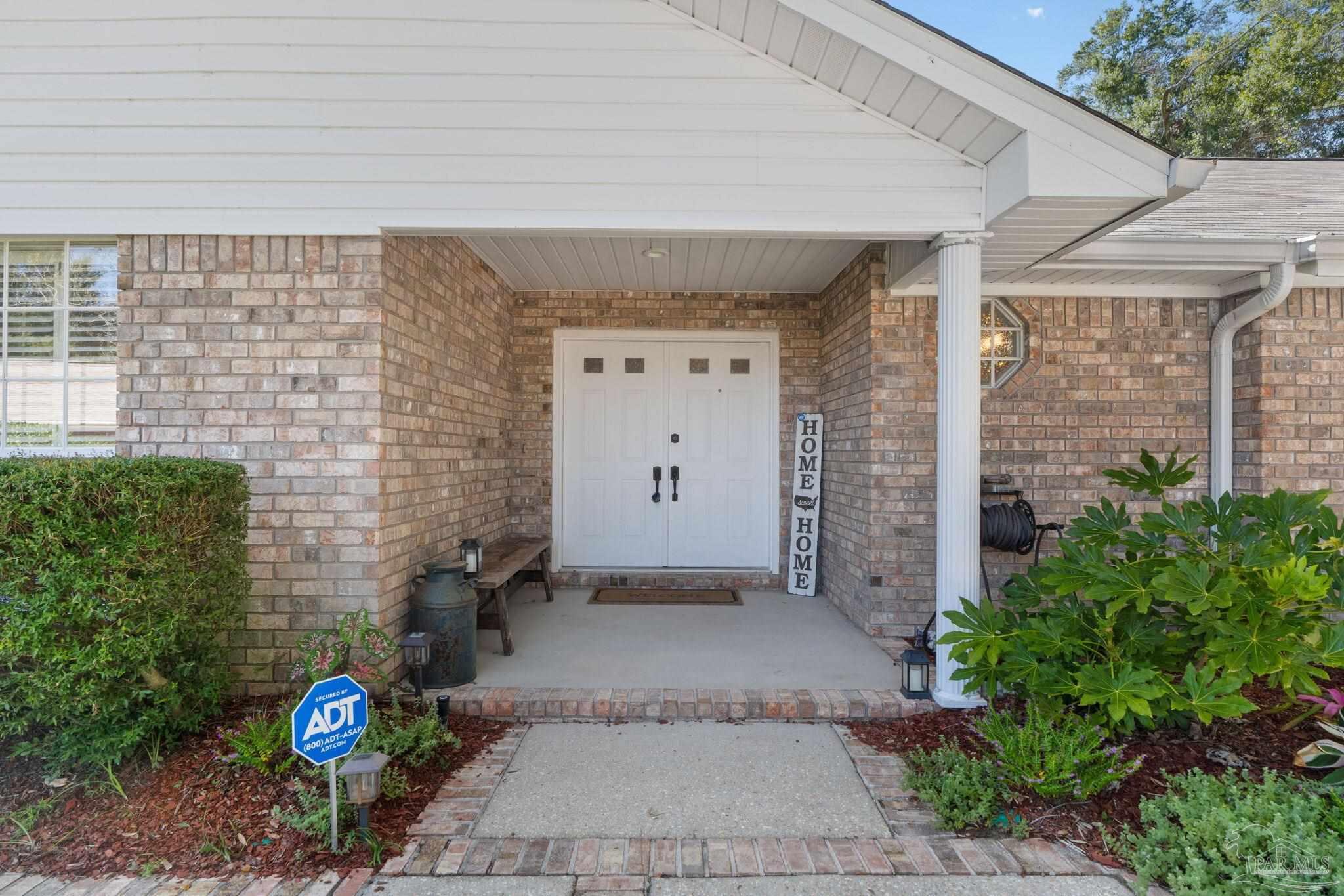 a front view of a house with plant