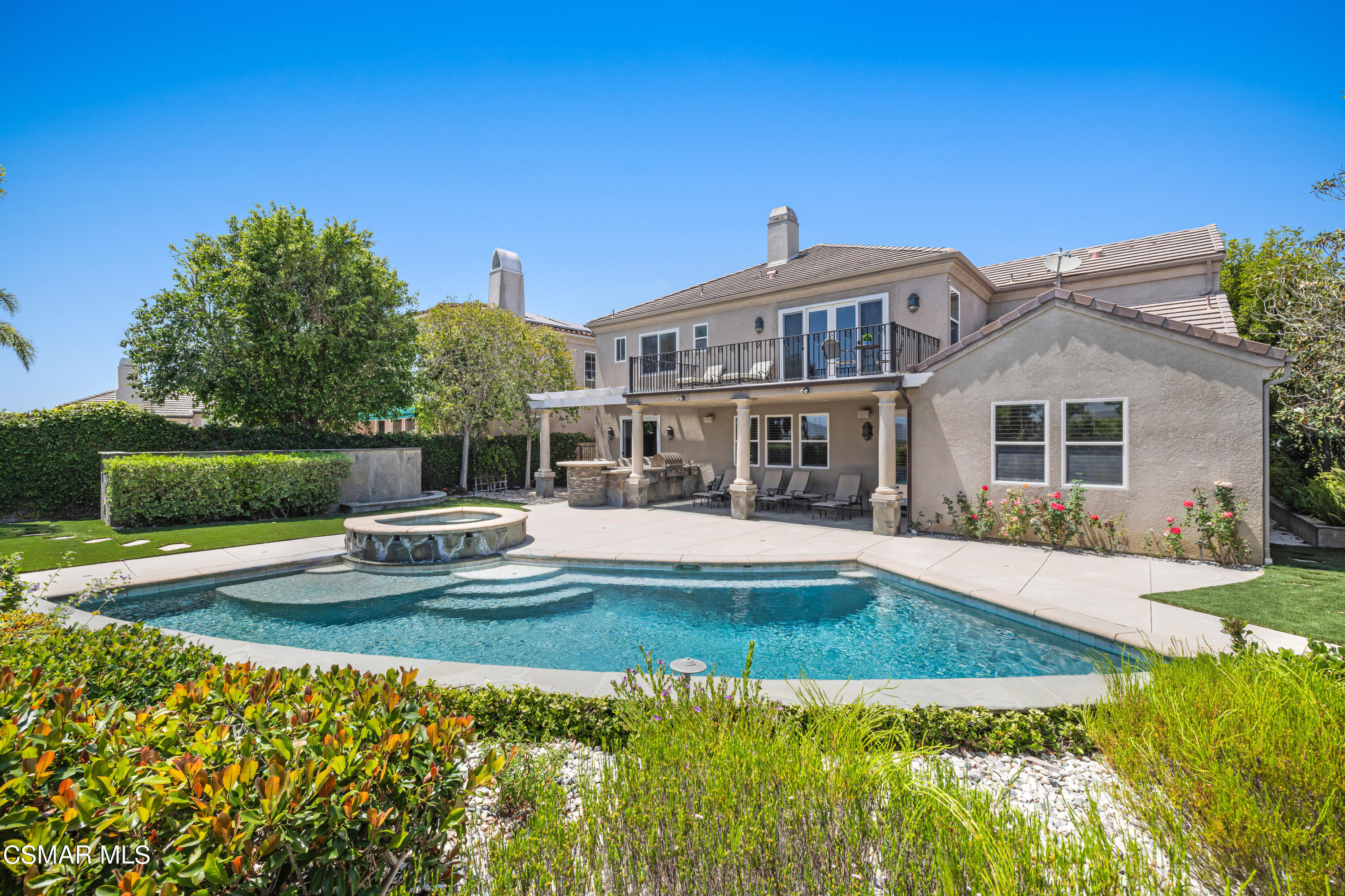 a view of a house with swimming pool and sitting area