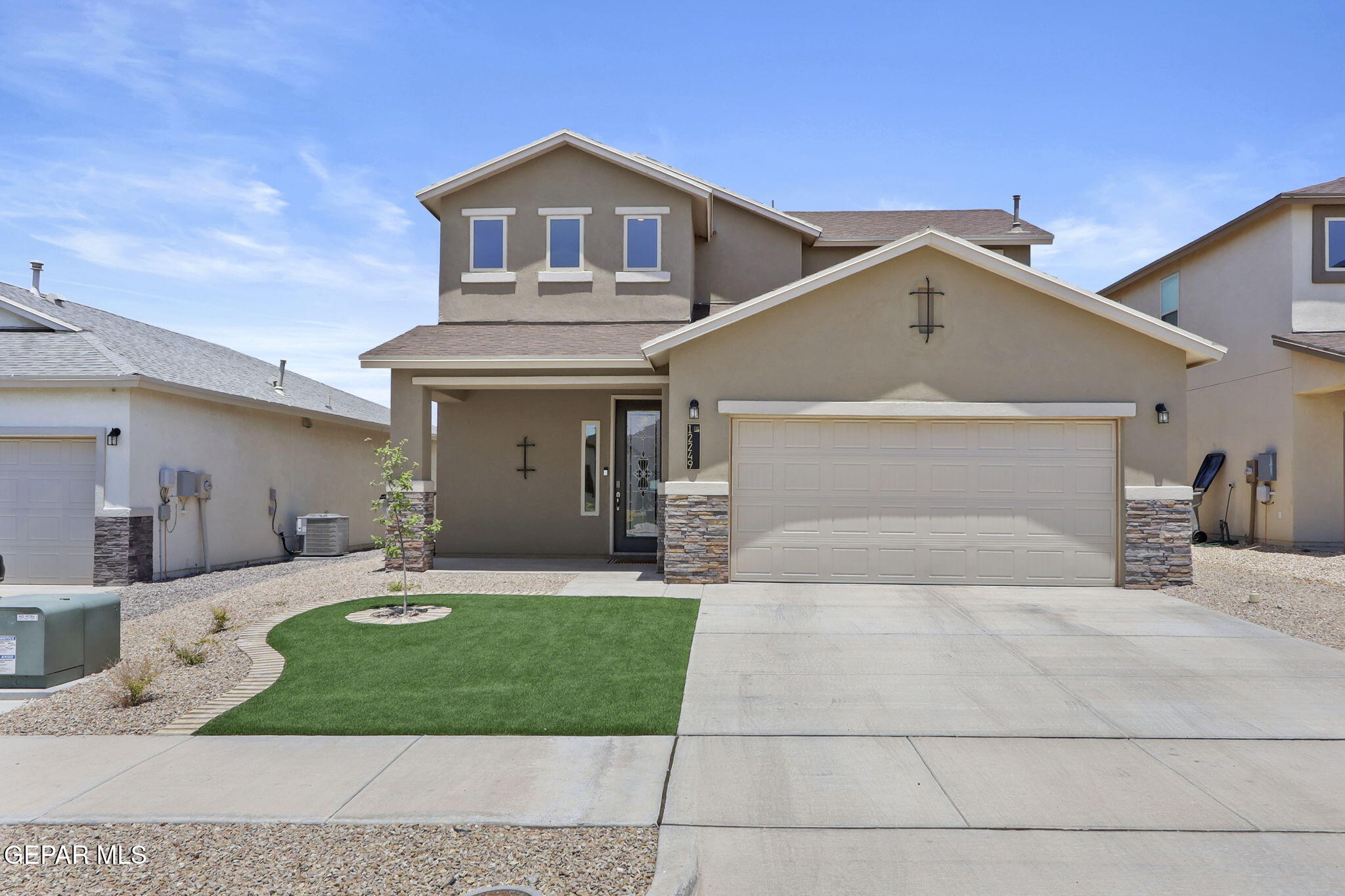 a front view of a house with a yard and garage