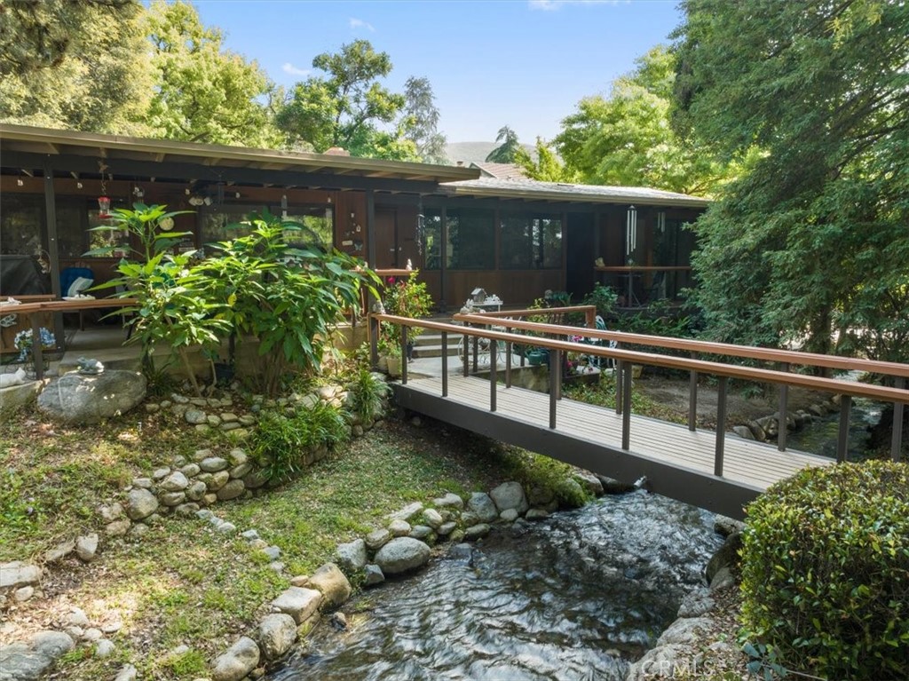 a view of a house with wooden fence