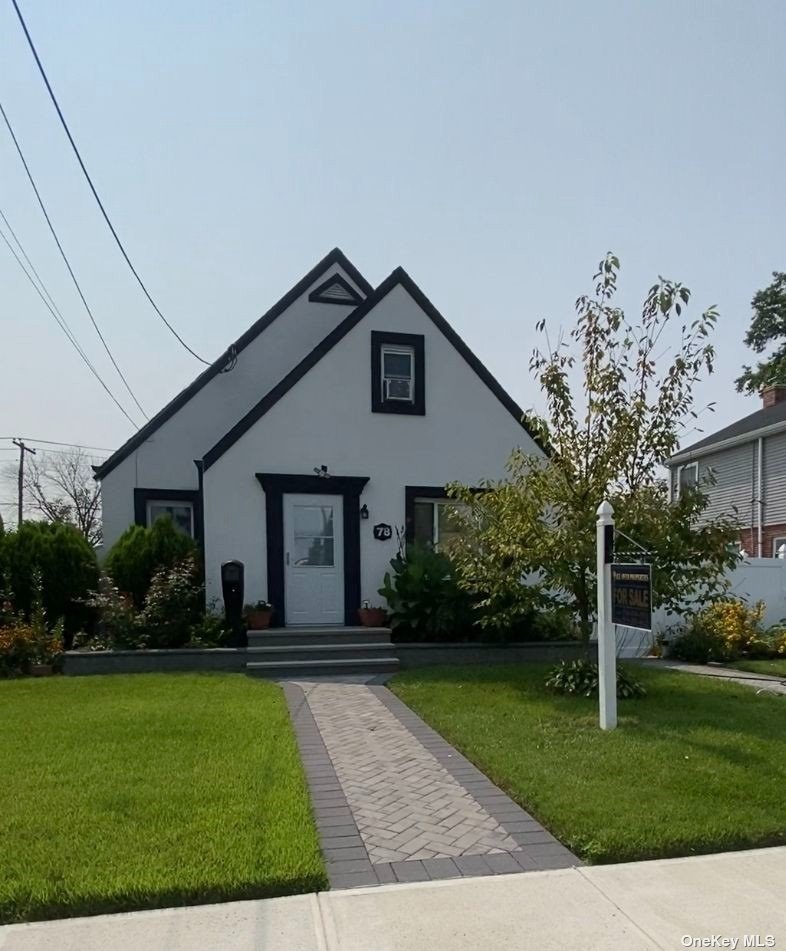 a front view of a house with garden