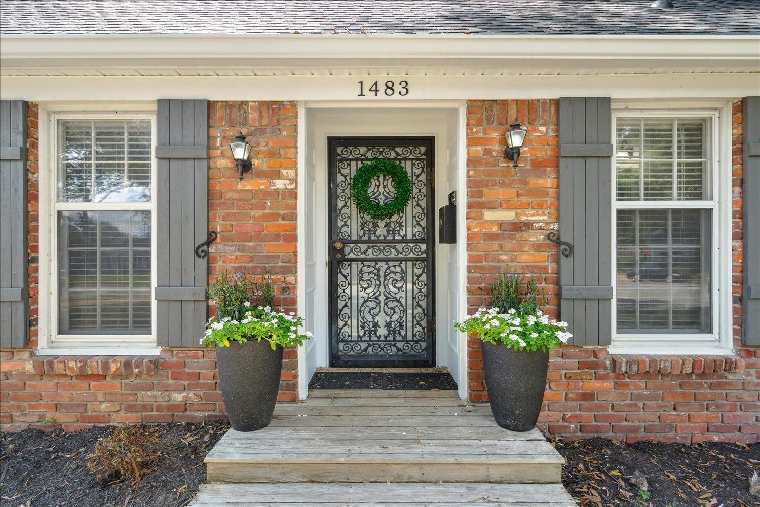 a view of front door of house with potted plant