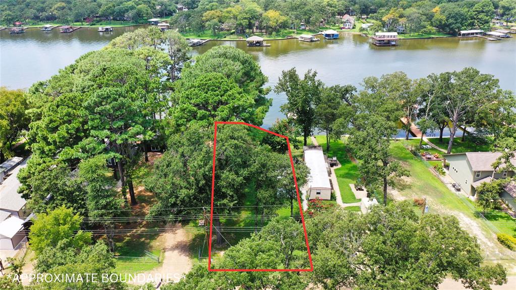 an aerial view of residential house with outdoor space and lake view