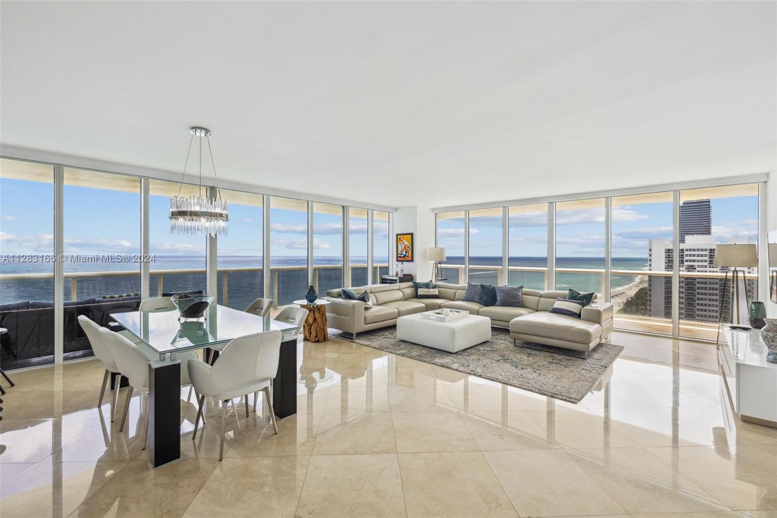 a living room with furniture and a floor to ceiling window