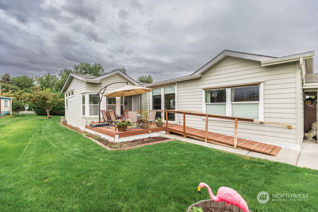 a front view of house with yard and outdoor seating