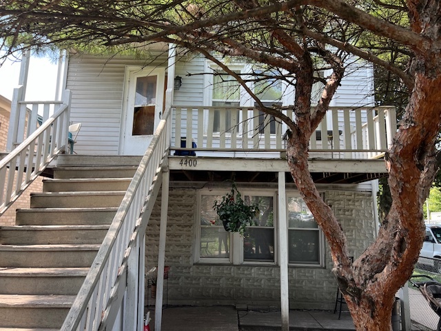 a view of a house with large tree