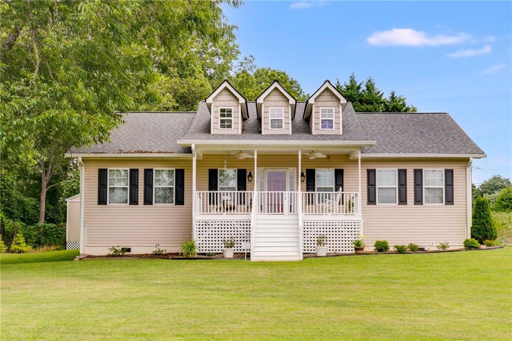 a front view of house with yard and garage