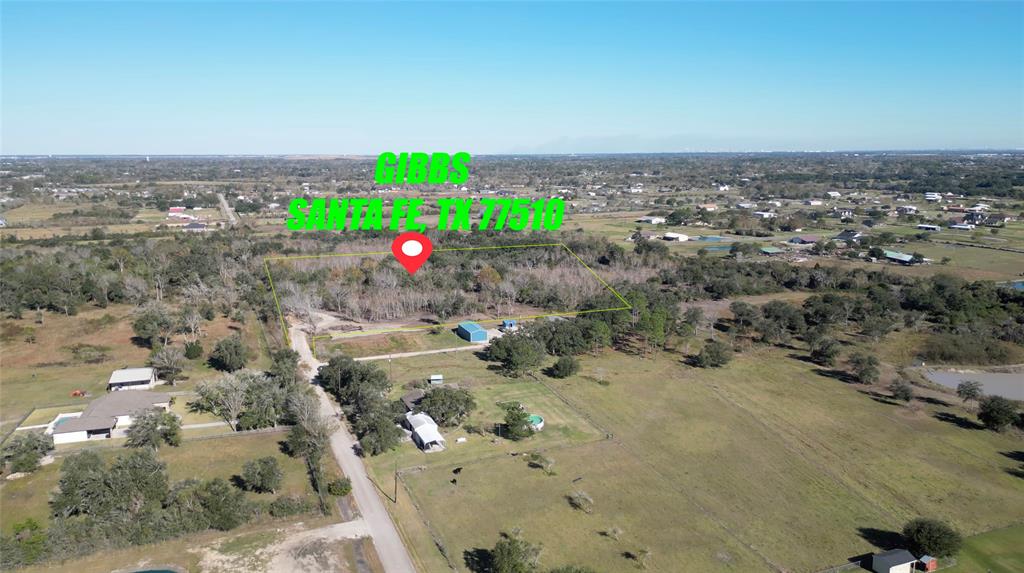 an aerial view of a houses with yard