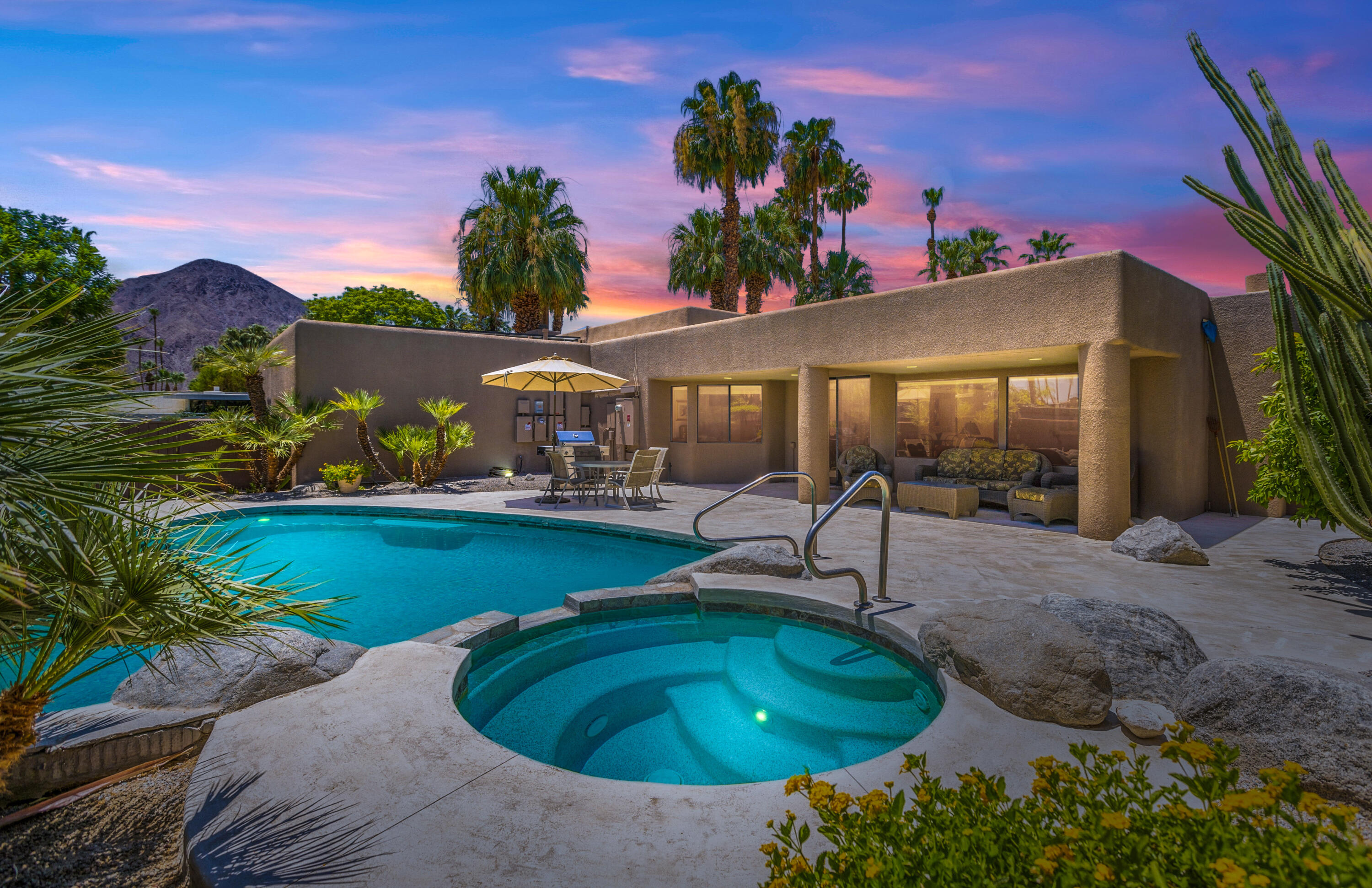 a swimming pool with outdoor seating and yard