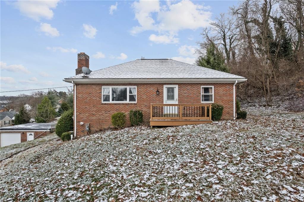 front view of a house with a bench