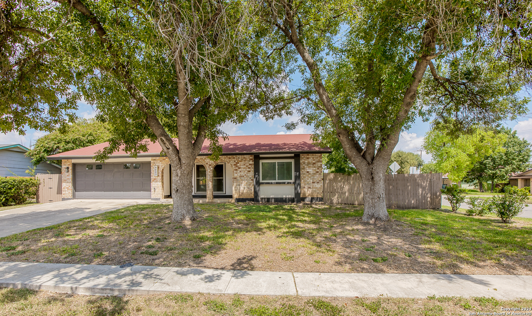 front view of a house with a tree