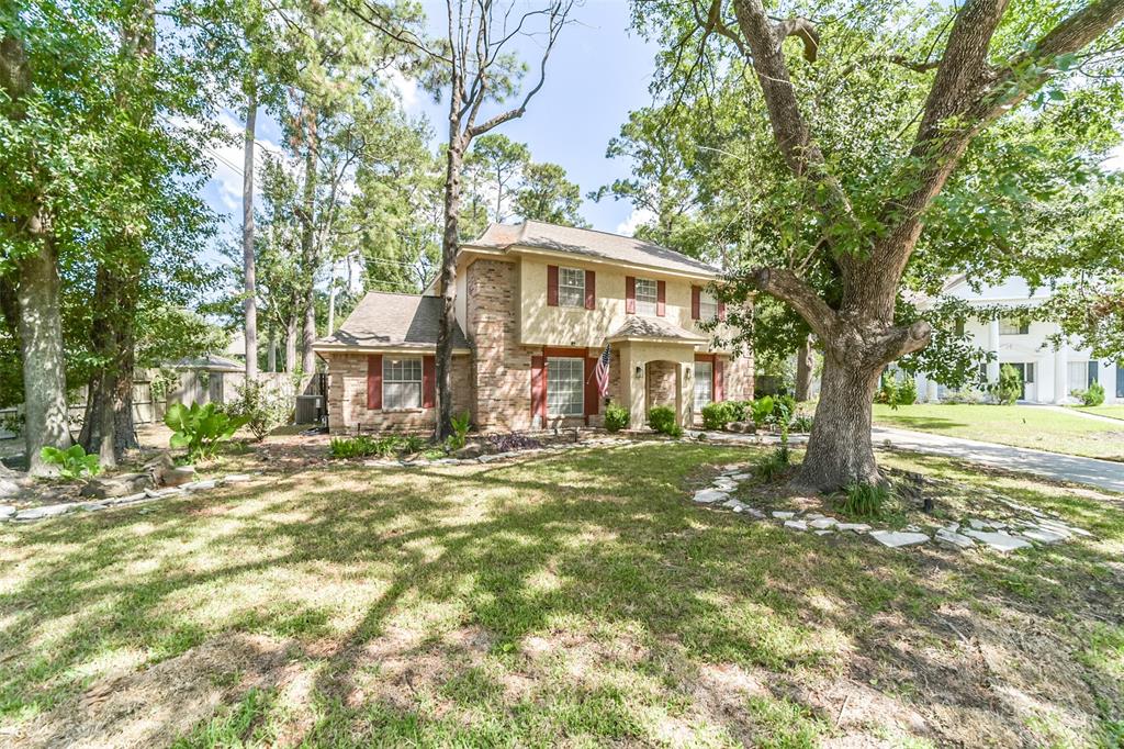 Welcome to 13410 Vestavia Court located on a cul-de-sac lot in a Champions Golf Club Community. This home is set back amidst mature trees and lush landscaping with a pathway leading to the front door.